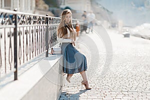 Fashion lifestyle portrait of young happy pretty woman laughing and having fun on the street at nice sunny summer day