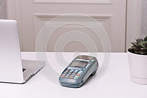 NFC payment terminal on a white table