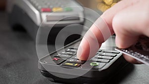 NFC technology. Close-up of young woman using credit card with NFC chip on bank terminal. Customer paying for food order