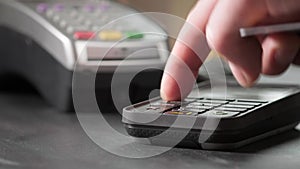 NFC technology. Close-up of young woman using credit card with NFC chip on bank terminal. Customer paying for food order