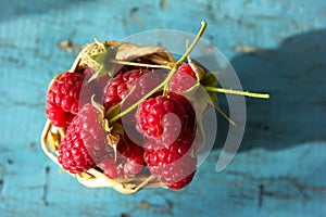 Fresh raspberries in vintage basket vitamins healthy food vegan ingredients. Selective focus