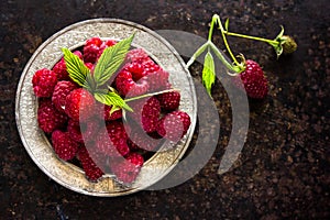 Fresh raspberries in vintage bowl vitamins healthy food vegan ingredients. Selective focus