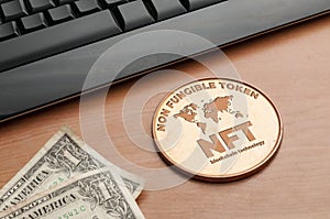 Nft non fungible token concept: big copper coin on a wooden table with a computer keyboard and two dollar bills