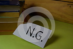 NG write on a sticky note isolated on Office Desk. Business Document concept