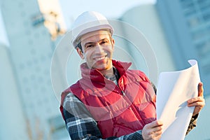 ngineer looking at plans outdoors