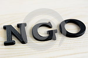 NGO letters on wood background