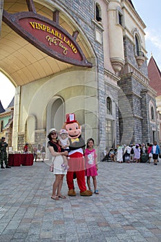 Nha Trang, Viet Nam - May 21,2018: Happy family at the port of Vinpearland Nha Trang with a big stuffed monkey animal