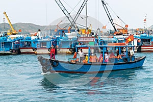 NHA TRANG, VIETNAM - APRIL 19, 2019: Boat with tourists and black old tires on board in the port for safety