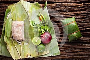 Nham sour pork in banana leaves thai food