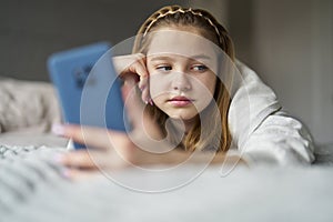 nhappy Teenage Girl With Mobile Phone Lying On Bed At Home Anxious About Social Media Online Bullying And Using Phone Too Much