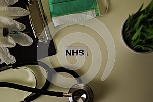 NHS with inspiration and healthcare/medical concept on desk background photo