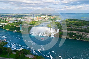 Niagara Falls. American falls. Boat with tourists moves along Bride Veil Falls. Canada, USA.