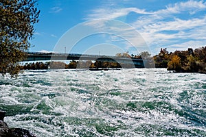 Niagara Falls from the American and Canadian sides. Rainbow over the waterfall. The most popular tourist place.