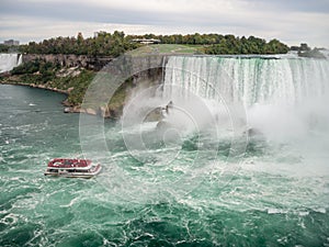 Niagara Falls, New York and Canada [ edge of Niagara falls, town from American and Canadian city side, falling water and mist ]