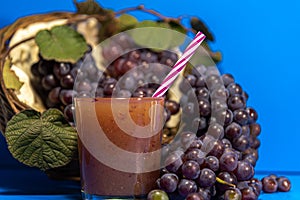 Niagara grape juice and bunches Vitis labrusca `Niagara` on blue background