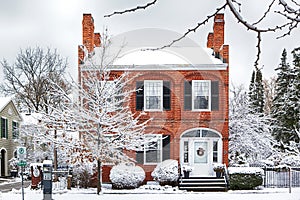 NIAGARA ON THE LAKE,CANADA - DECEMBER 2, 2019: Beautiful house covered snow located in the Queen Street, Niagara on the Lake,