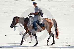 Nicaraguan Cowboy on Horseback along a Beach.