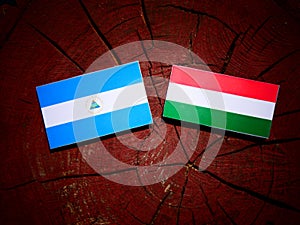 Nicaraguan flag with Hungarian flag on a tree stump isolated