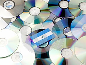 Nicaraguan flag on top of CD and DVD pile isolated on white