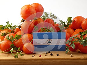 Nicaraguan flag on a wooden panel with tomatoes isolated on a wh