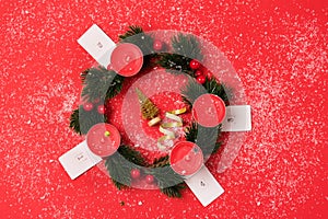 Nice Advent Wreath Red Candles Golden Christmas Ornaments on Red Background Snow Holiday Minimal Concept Top View