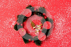 Nice Advent Wreath Red Candles Golden Christmas Ornaments on Red Background Snow Holiday Minimal Concept Top View