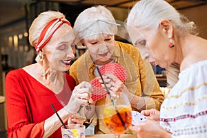 Nice aged women looking at their cards