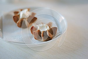 Nice appetizer snacks - tartlets on a white ceramic plate.