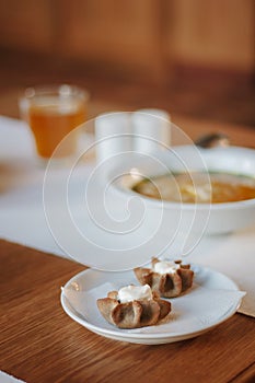 Nice appetizer snacks - tartlets on a white ceramic plate.