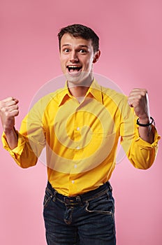 Nice attractive handsome cheerful cheery guy wearing yellow shirt