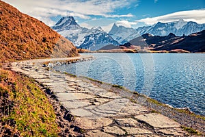 Nice autumn scene of Bachsee lake with Wetterhorn and Wellhorn peaks on background. Colorful morning in Bernese Oberland Alps, Gri