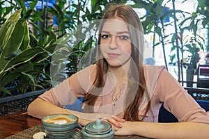 Nice blond haired girl with cup of cappuccino