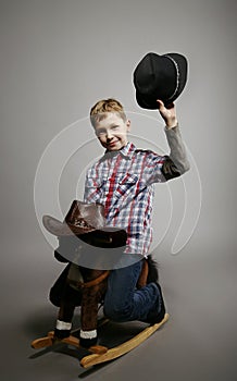 Nice boy in hat on a horse