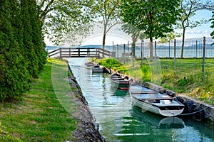 nice bridge with a small canal in Balatonbolar and fishng boats next to Lake Balaton