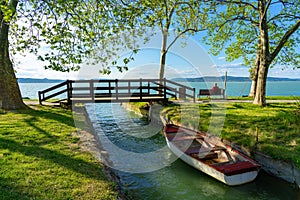 nice bridge with a small canal in Balatonbolar and fishng boats next to Lake Balaton