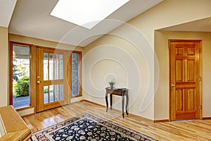 Nice bright entry way to home with hardwood floor and rug.