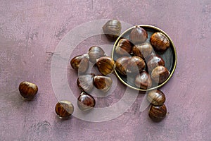 A nice bunch of edible chestnuts on a vintage metal plate