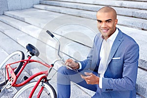 Nice businessman sitting on the stairs