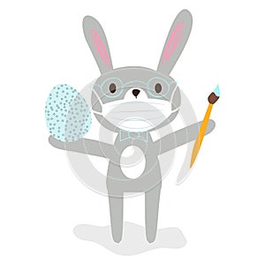 Nice cartoon grey rabbit in glasses with protective medical face mask holding a brush and easter egg. Happy easter stay