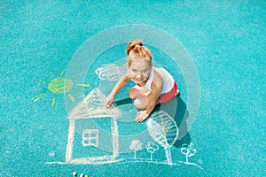 Nice Caucasian little girl draw chalk house image