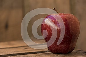 Red apple on an old wooden table photo