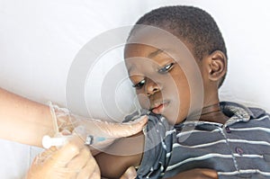 Healthcare and Medical symbol: African black boy gets a vaccination needle