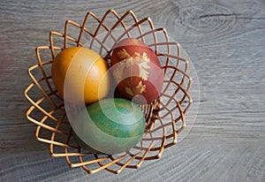 Nice colorful Easter eggs in a knit basket - close up view.