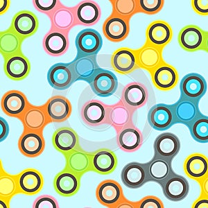 Nice colorful fidget spinners on light blue background seamless pattern