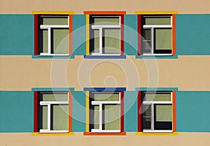 nice colorful house a kindergarten for children. six windows, blue, yellow and beige color.
