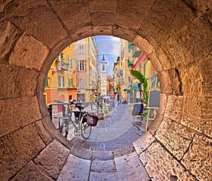 Nice colorful street architecture and church view through stone window