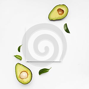 Nice composition of avocado on white background with a frame for text