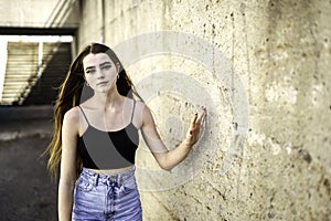 Nice and cool teen girl standing portrait on concreate place