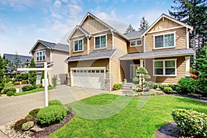 Nice curb appeal of American two story house with perfect landscape design.