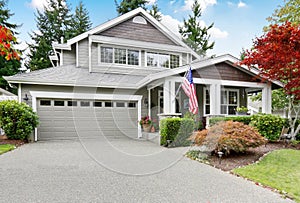 Nice curb appeal of grey house with covered porch and garage photo